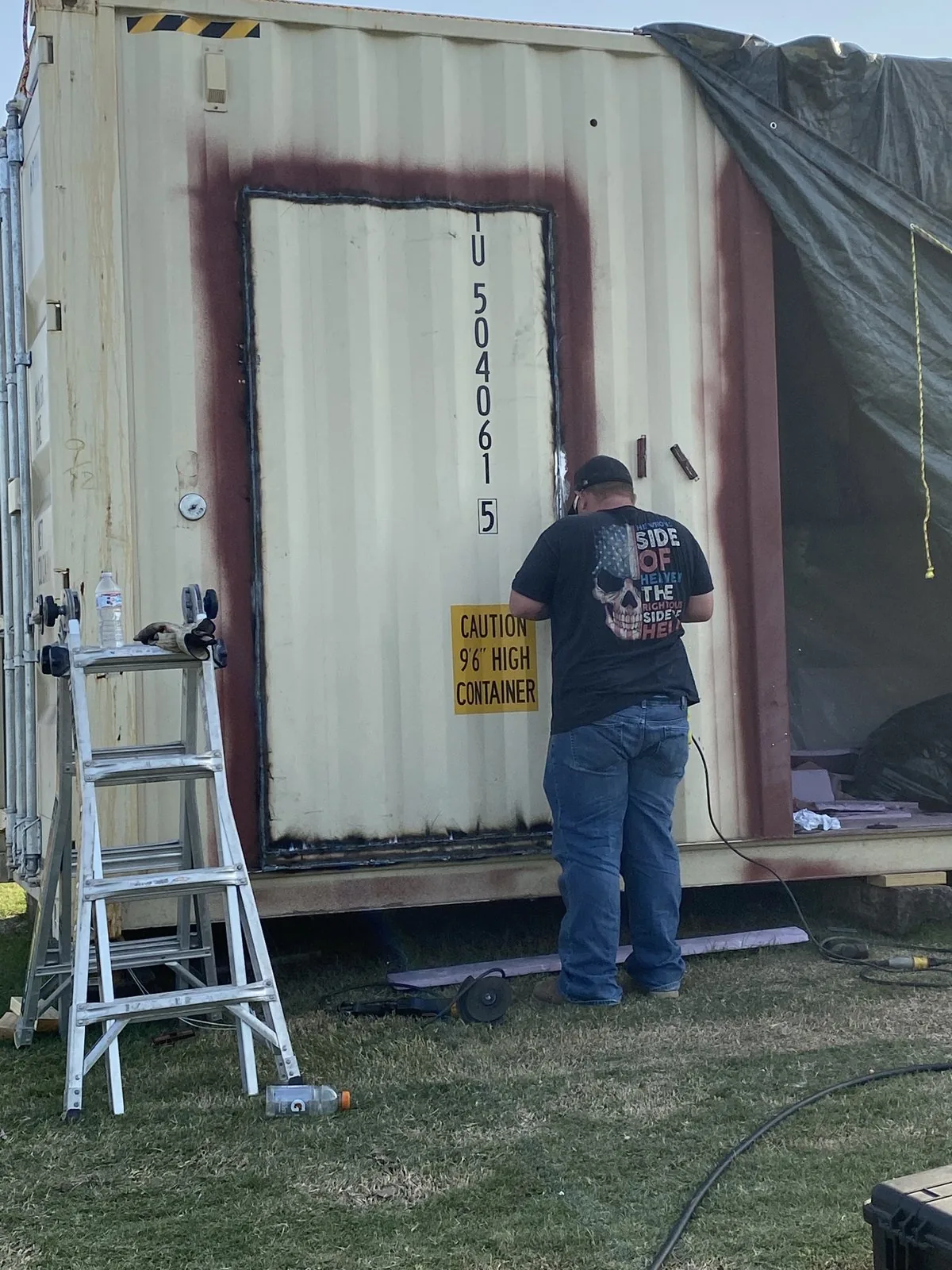 Cutting and welding a new doorway opening into a shipping container