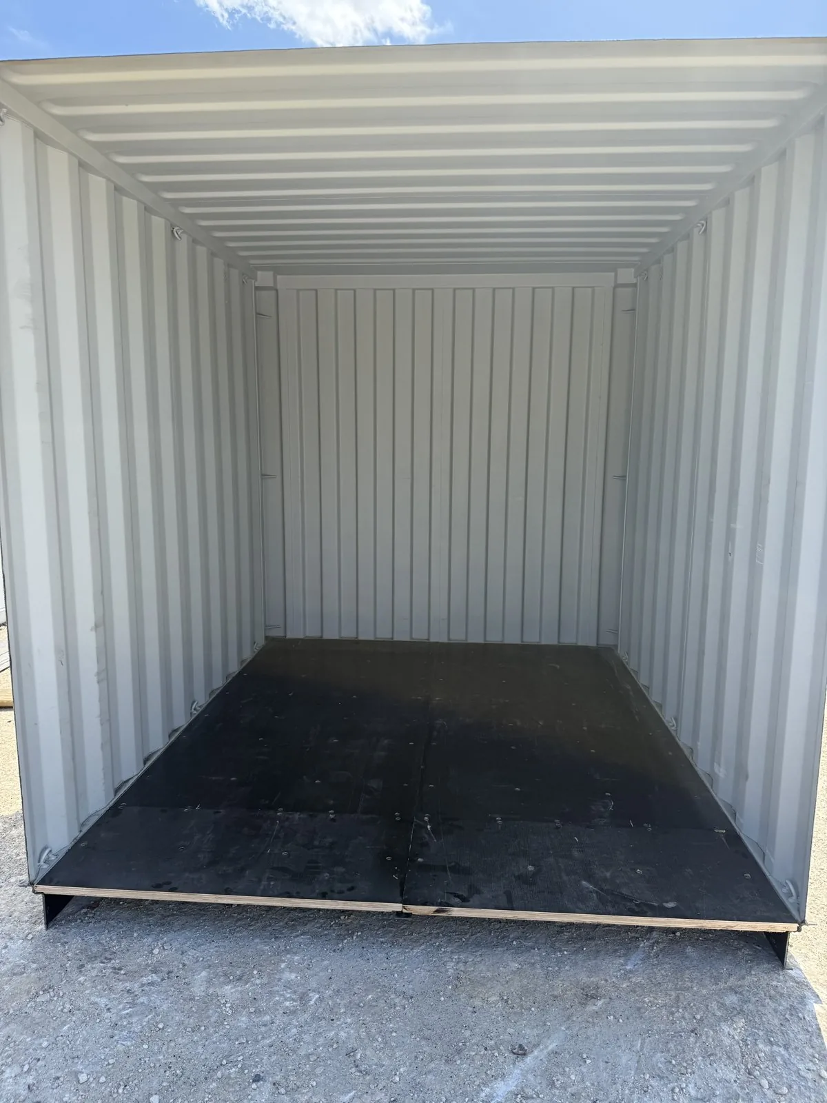 Finished interior of a modified shipping container with sealed floor