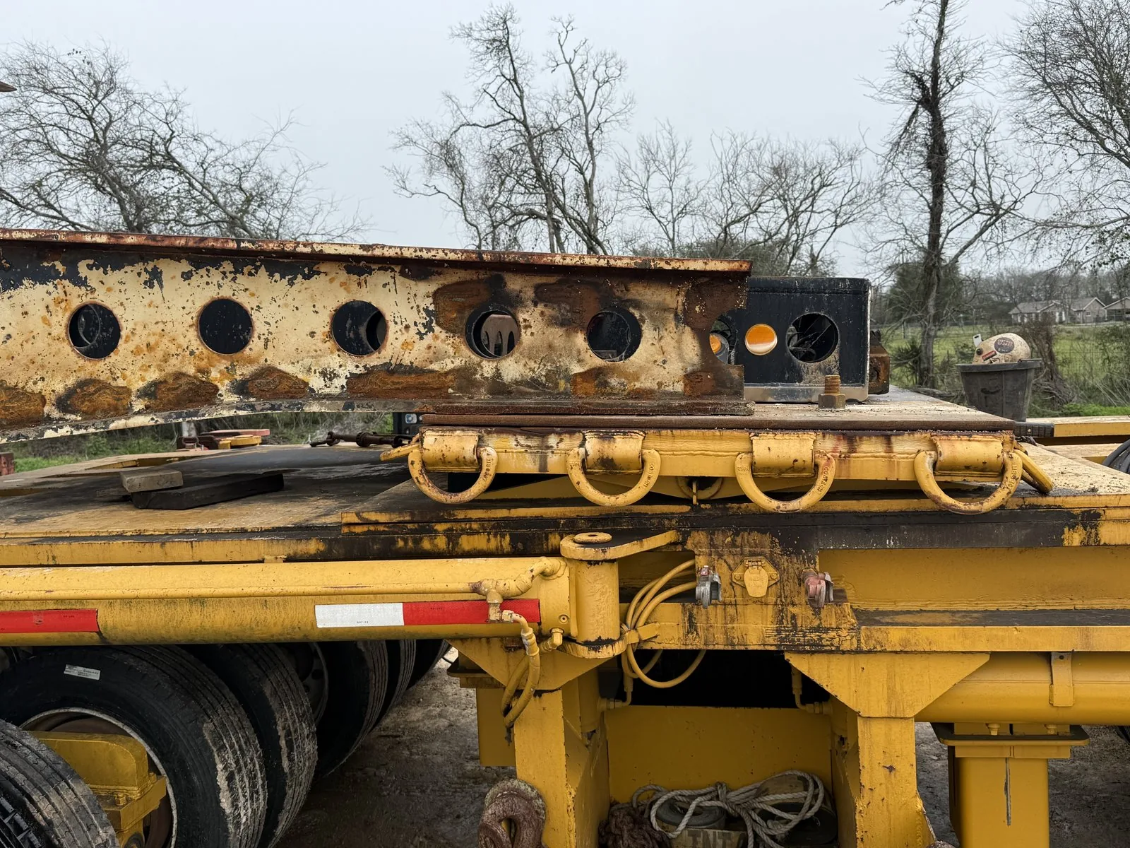 Heavy-haul lowboy trailer carrying a fabricated steel beam