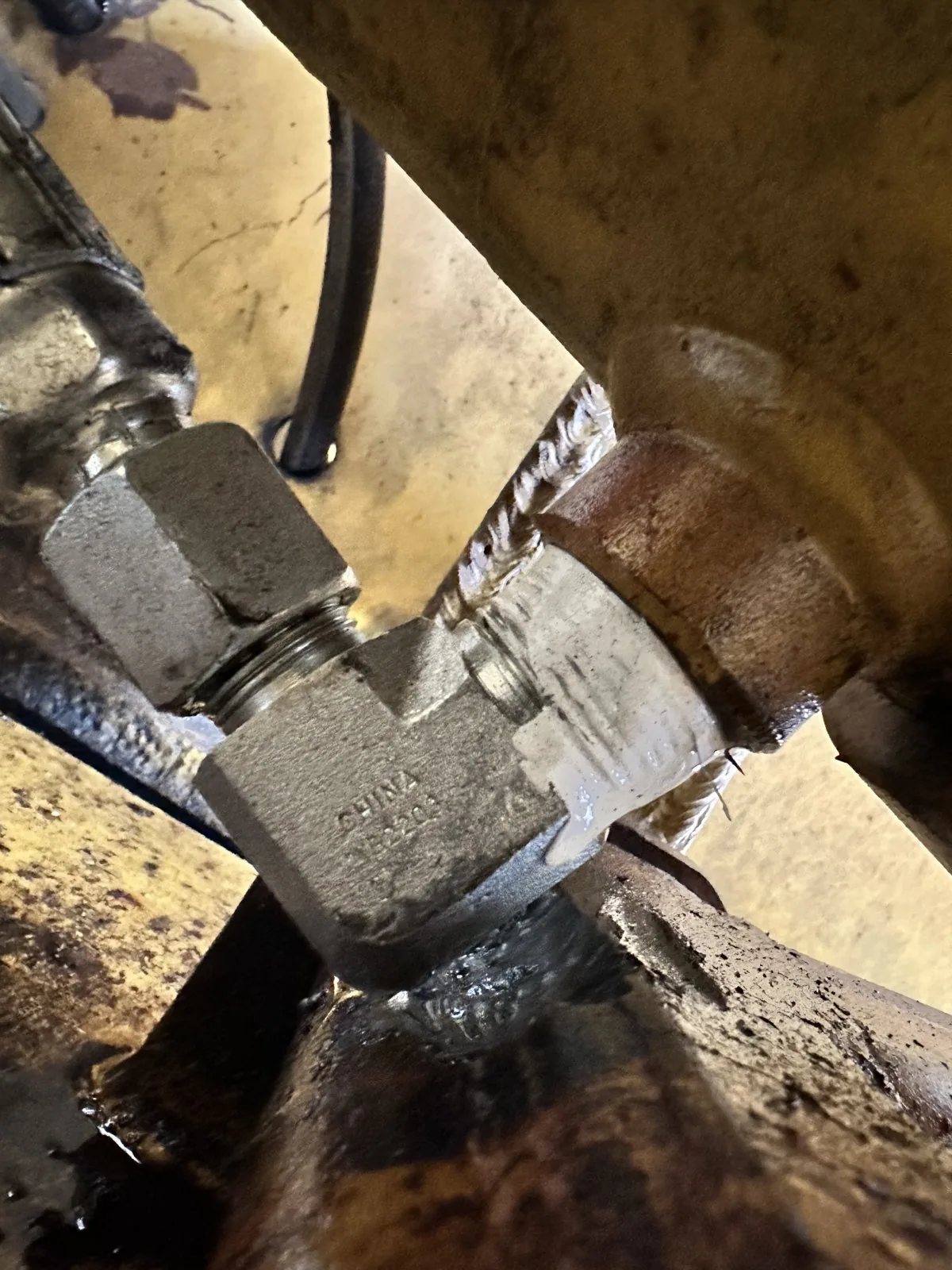 Close-up of a clean stacked weld bead on a steel fitting